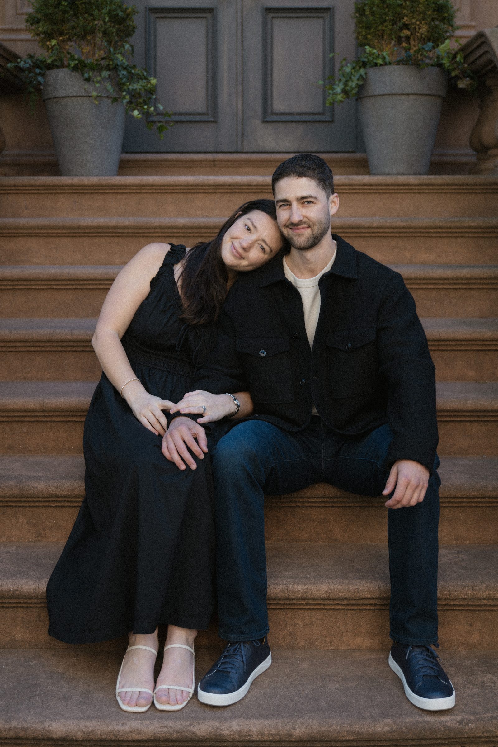 Taylor and Jake sitting on a brownstone stoop