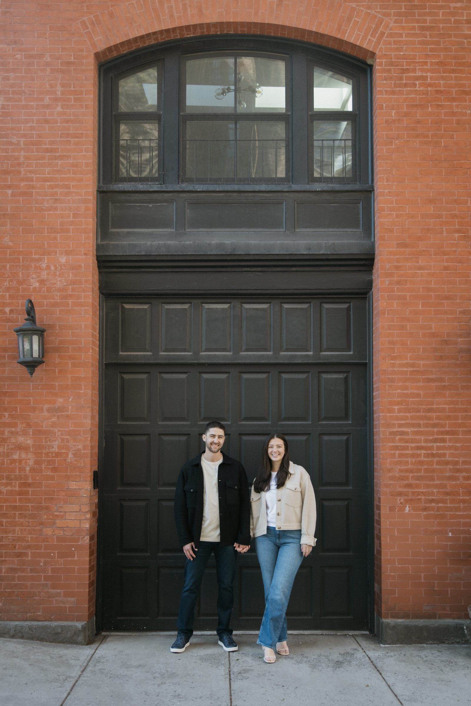 Taylor and Jake in front of a red brick archway