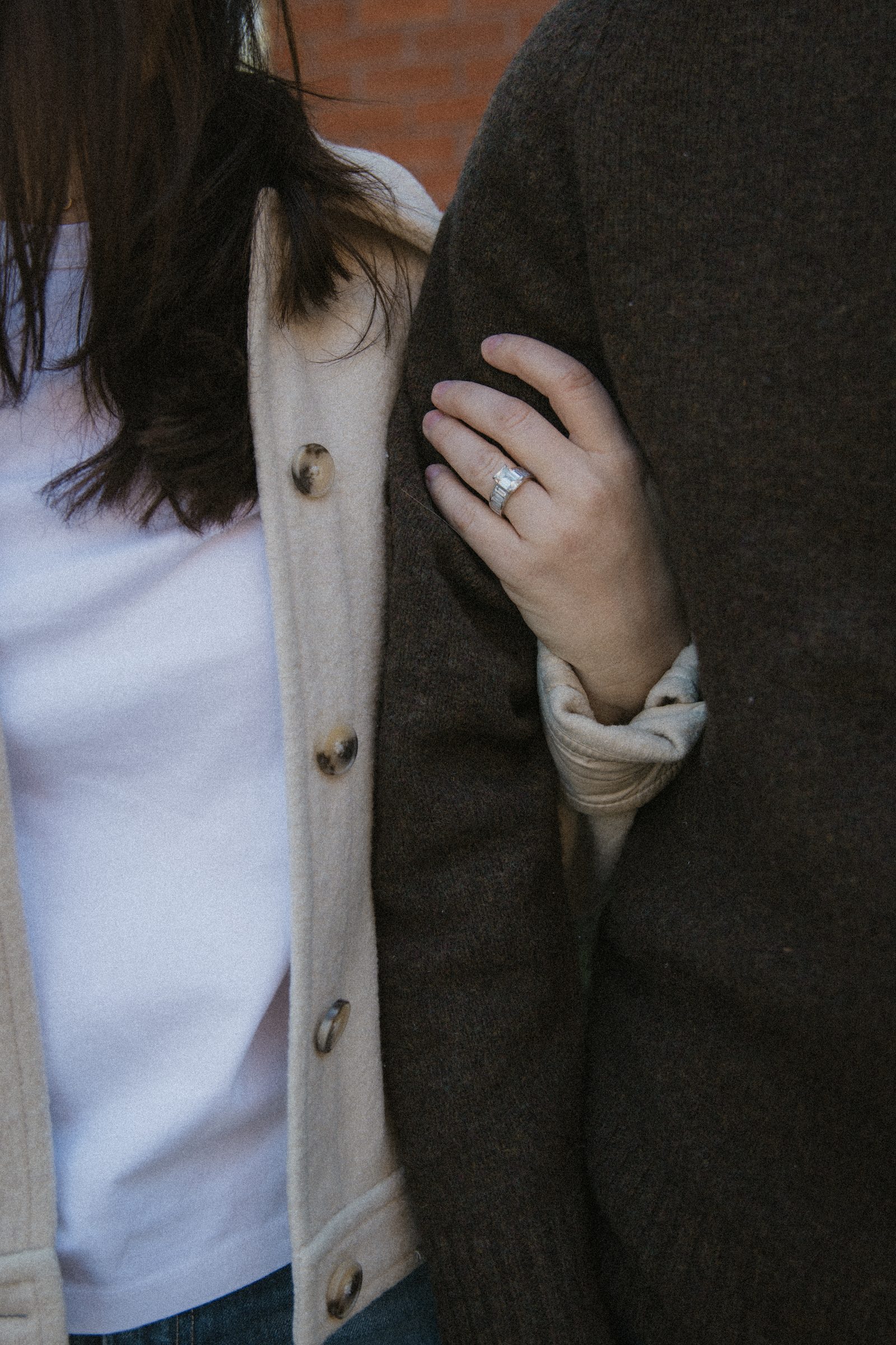 Taylor’s engagement ring as they hold arms