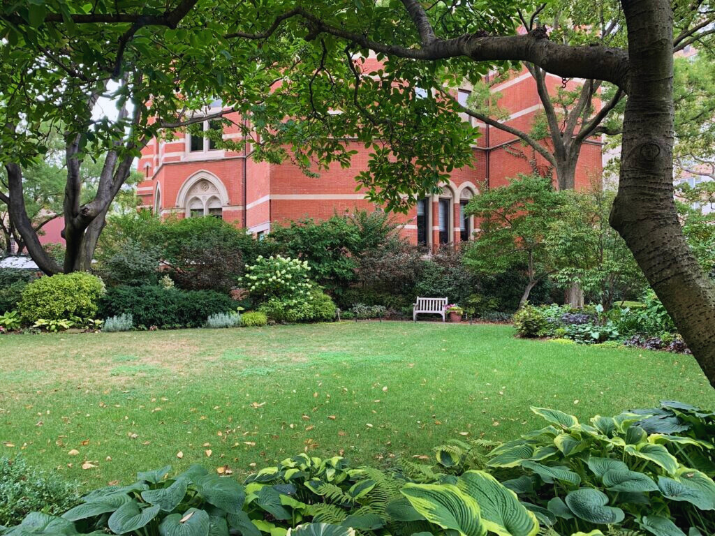 A brick path through the lush Jefferson Market Garden in Greenwich Village